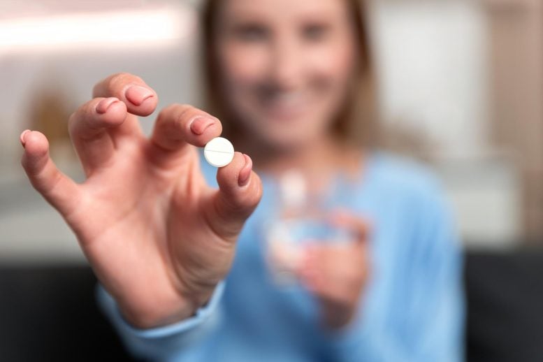 Young Woman Hand Holding White Pill Smiling