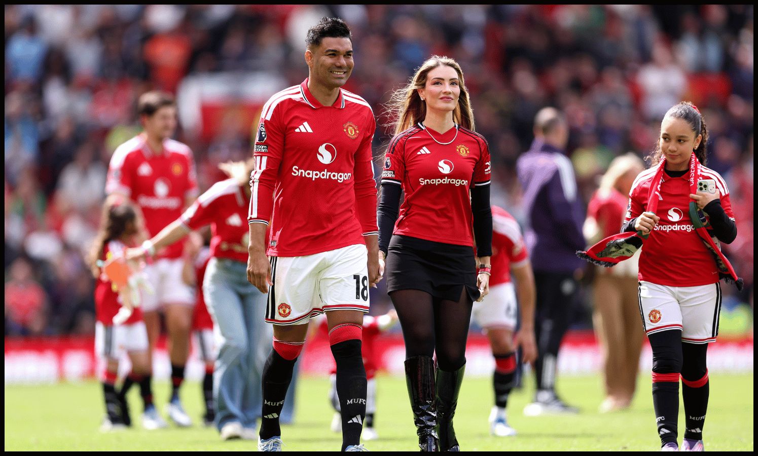 MANCHESTER, ENGLAND - MAY 17: Casemiro of Manchester United and Anna Mariana Casemiro parade on the pitch after the Premier League match between Manchester United and Nottingham Forest at Old Trafford on May 17, 2026 in Manchester, England.