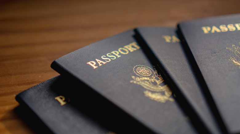 A stack of United States passports on wooden surface