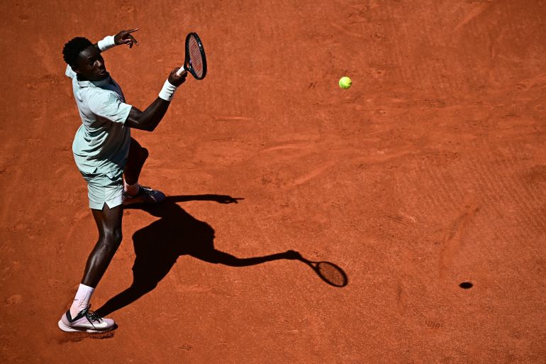 France's Moise Kouame plays a forehand return to Croatia's Marin Cilic during their men's singles match on day 3 of the French Open tennis tournament on Court Simonne-Mathieu at the Roland-Garros Complex in Paris on May 26, 2026. (Photo by JULIEN DE ROSA / AFP)