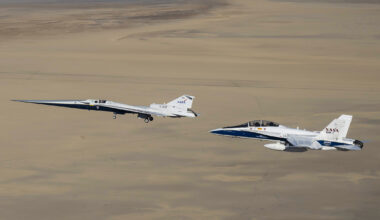 NASA’s X-59 flies above the Mojave Desert with a NASA F/A-18 chase aircraft nearby.