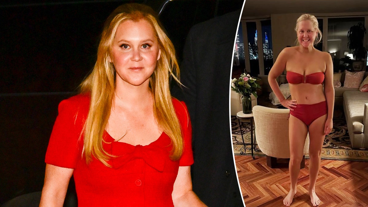 Amy Schumer standing and smiling in a black outfit