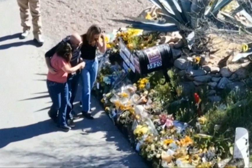 This image made from video provided by FOX News Digital shows Savannah Guthrie, right, her sister Annie Guthrie, left, and her brother-in-law Tommaso Cioni, visiting a tribute to their mother Nancy Guthrie on March 2.