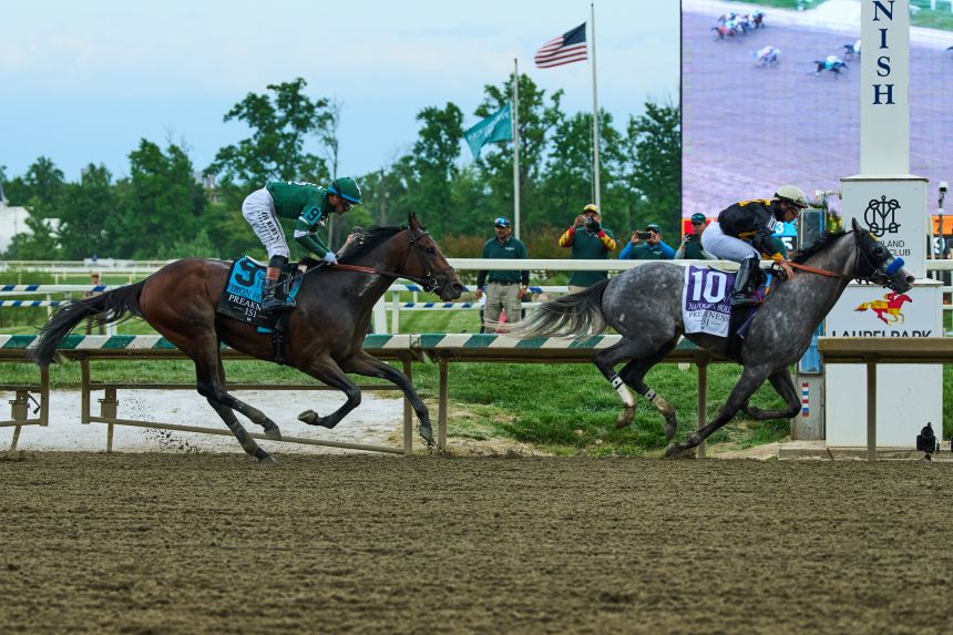 Paco Lopez, right, atop Napoleon Solo, edges out Iron Honor, ridden by Flavien Prat, to win the 151st running of the Preakness Stakes.