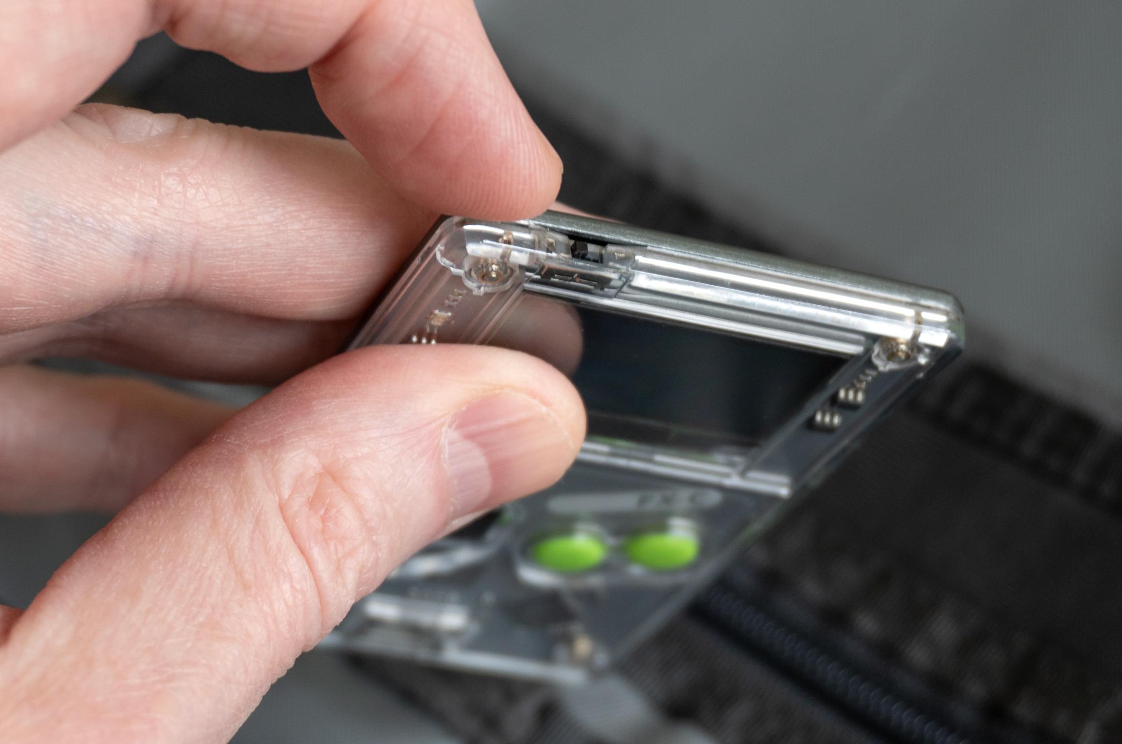 A close-up of the sliding power switch on top of the Arduboy FX-C.