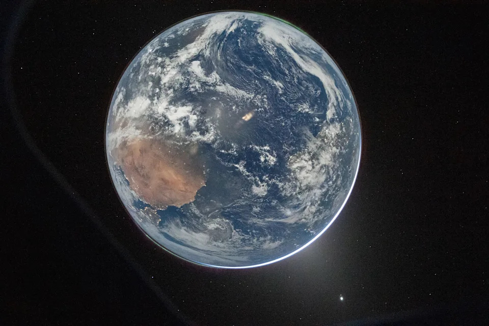 A nighttime picture of Earth taken from the window of the Orion spacecraft.