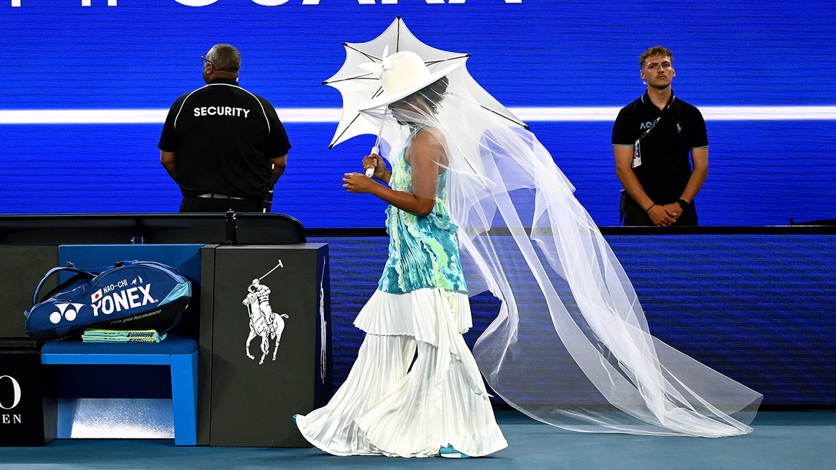 Naomi Osaka walking onto Rod Laver Arena tennis court in Melbourne
