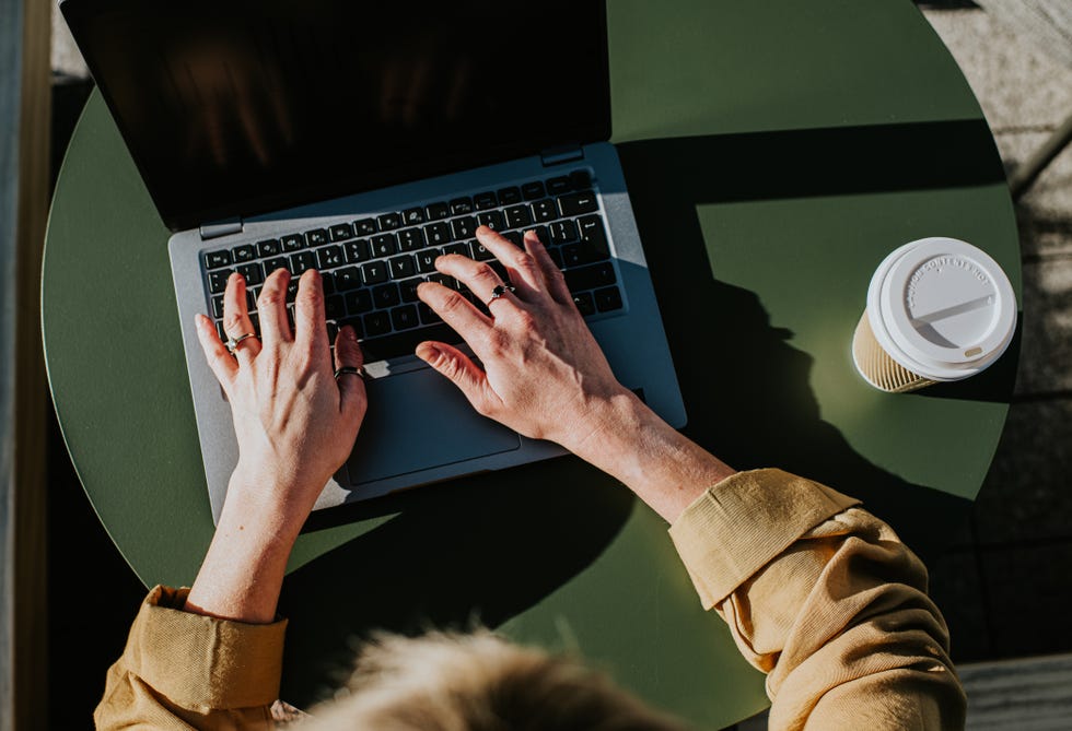 close up of hands typing on a laptop computer