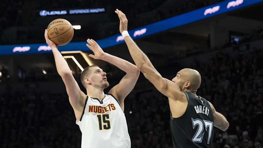 Nikola Jokic (15) shoots the ball over Minnesota Timberwolves center Rudy Gobert