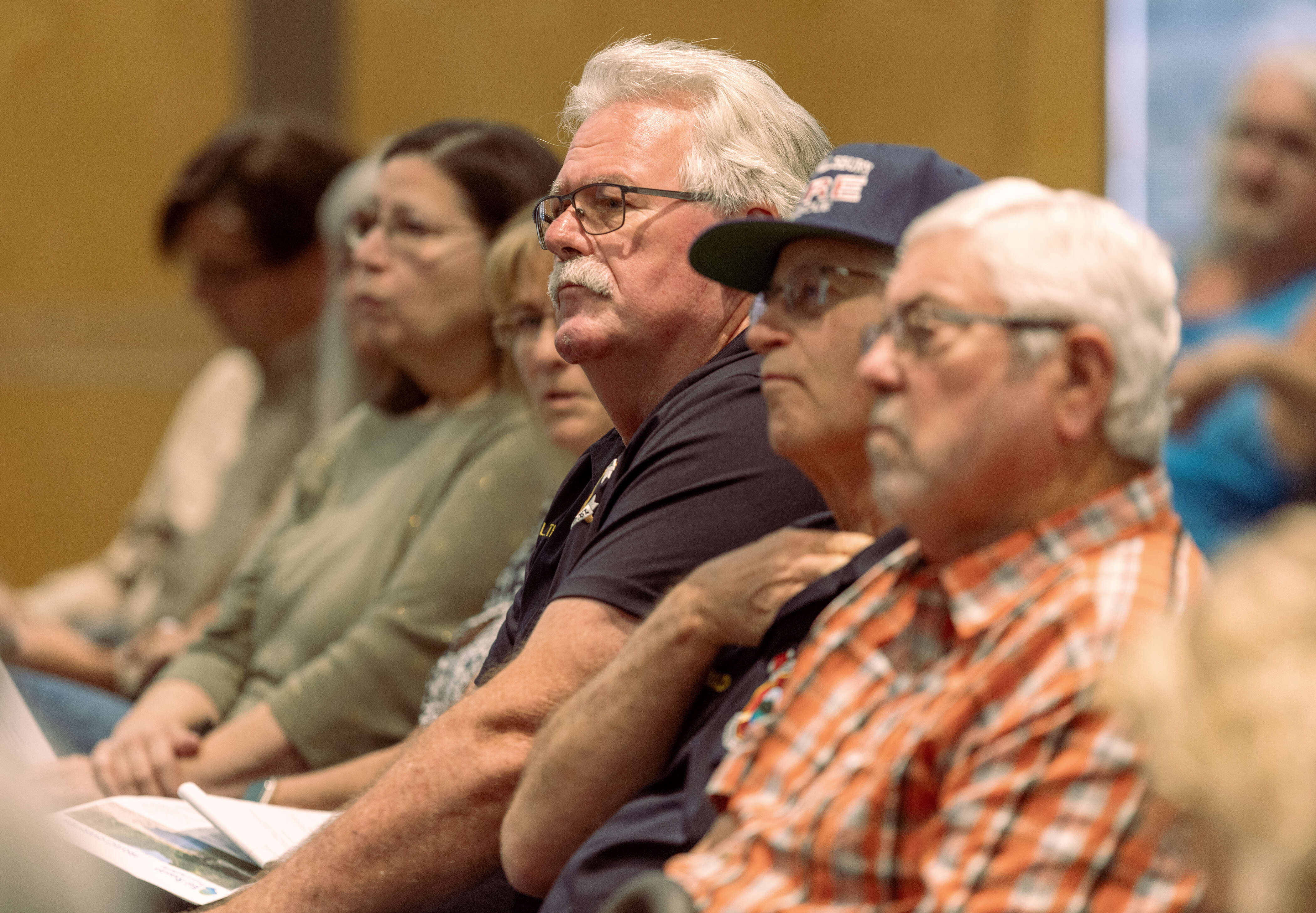 Audience members listen to plans and economic forecasts on Tuesday,...