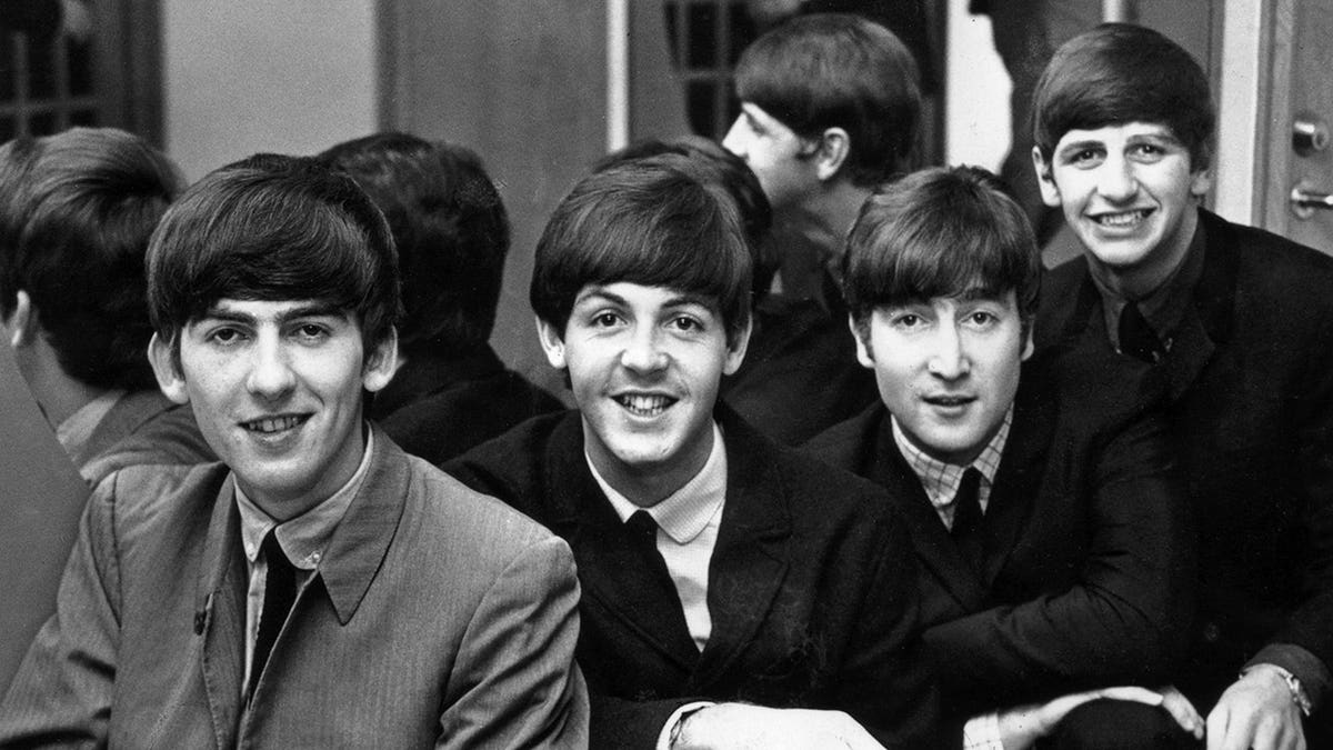 The Beatles standing together in Sweden in 1963 from left George Harrison Paul McCartney John Lennon and Ringo Starr