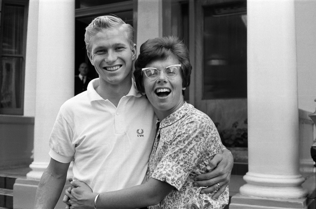 Billie Jean King and husband Larry smiling and hugging.