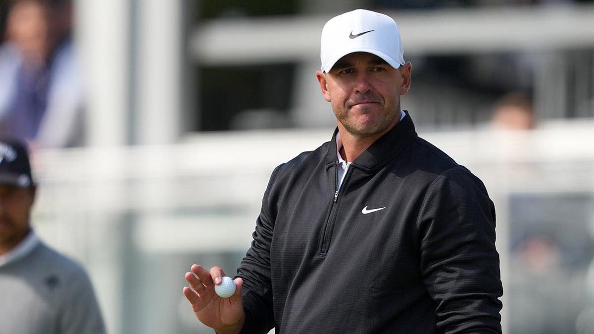 Brooks Koepka reacting after a putt on the 14th green at Aronimink Golf Club