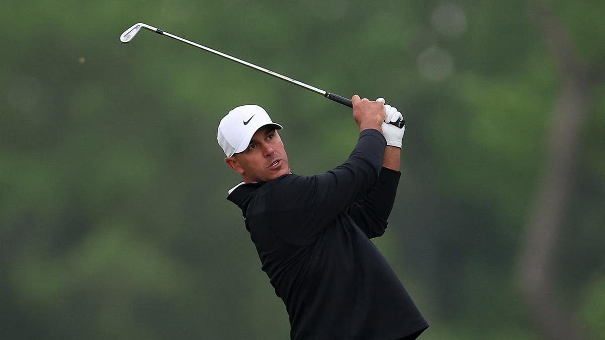 Brooks Koepka playing a golf shot on the tenth hole at Aronimink Golf Club