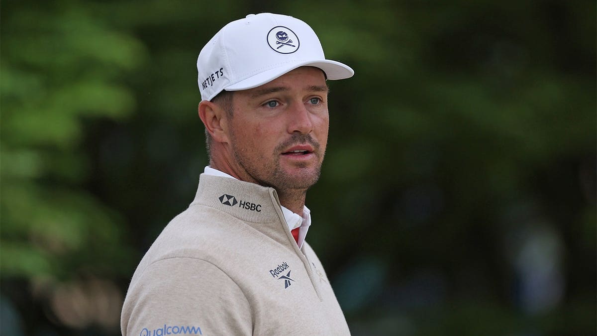 Bryson DeChambeau looking on during a practice round at Aronimink Golf Club.