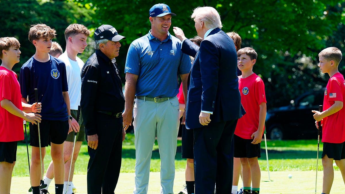 Golfer Bryson DeChambeau speaking with President Donald Trump on the White House south lawn