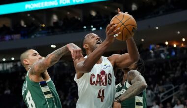 Cleveland Cavaliers' Evan Mobley (4) shoots between Milwaukee Bucks' Kyle Kuzma (18) and Kevin Porter Jr. during the first half of an NBA basketball game Tuesday, March 17, 2026, in Milwaukee.