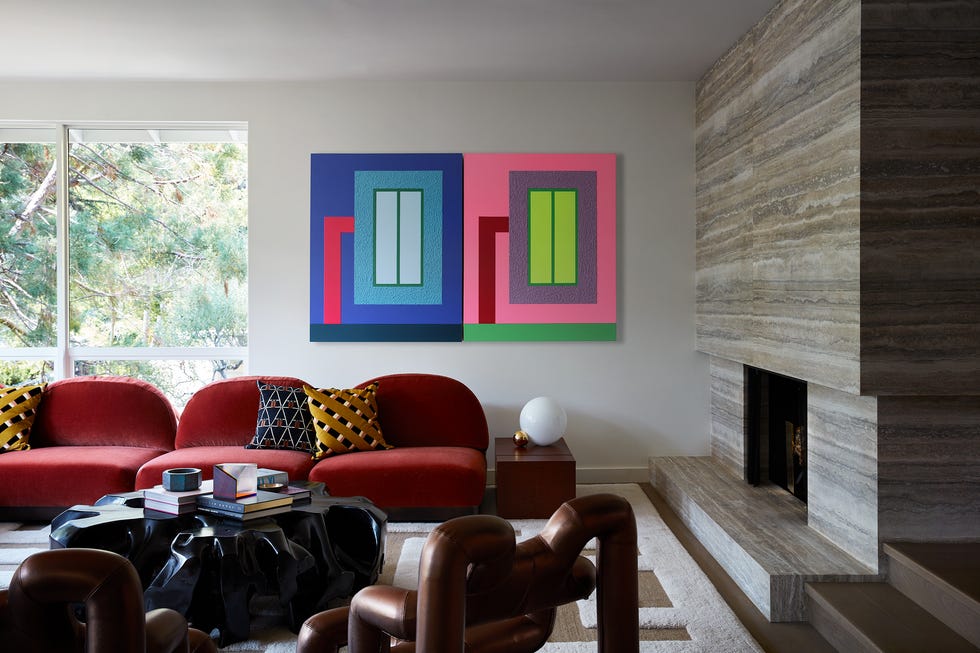 Modern living room featuring bold artwork and stylish furniture.