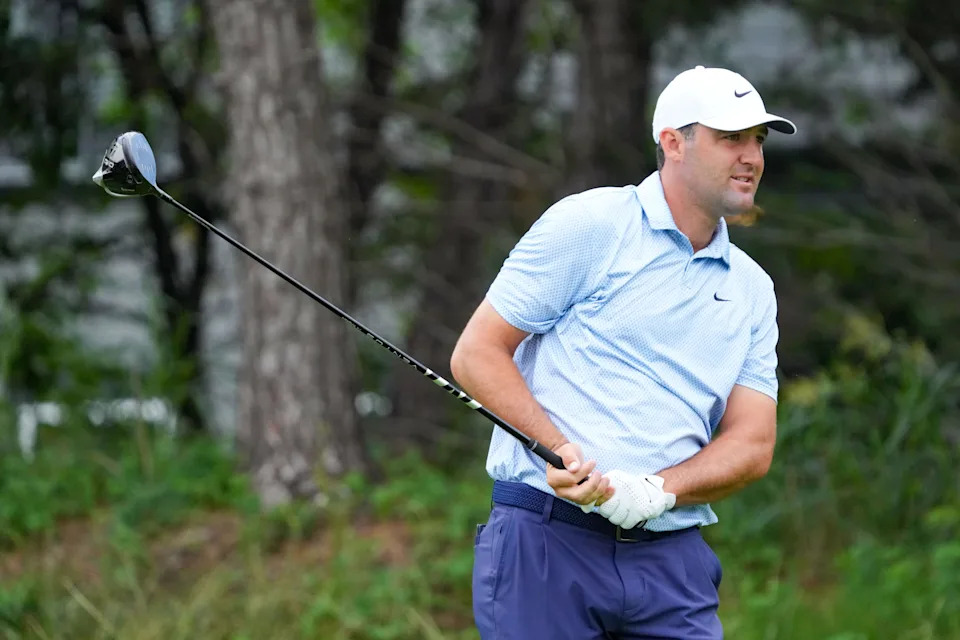 May 21, 2026; McKinney, Texas, USA; Scottie Scheffler plays his shot from the 14th tee during the first round of THE CJ CUP Byron Nelson golf tournament. Mandatory Credit: Raymond Carlin III-Imagn Images