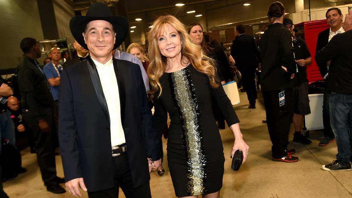 Musician Clint Black and actress Lisa Hartman Black standing together at an event.