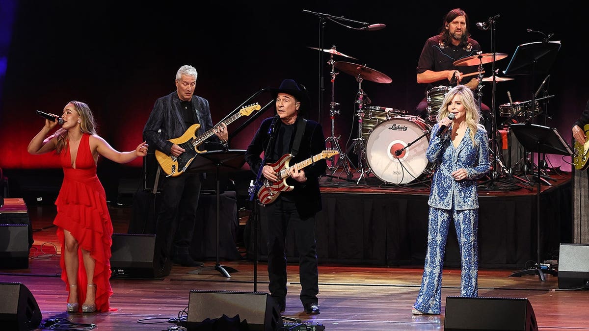 Lily Pearl Black, Clint Black and Lisa Hartman Black performing on stage in Nashville