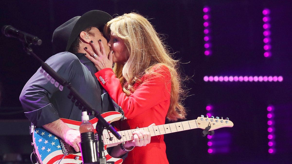 Clint Black and Lisa Hartman Black standing together at a music event