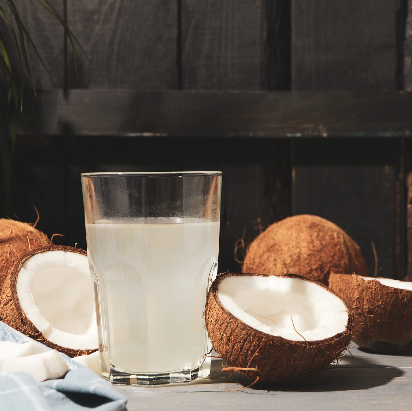 coconut and water on wooden background, space for text tropical fruit