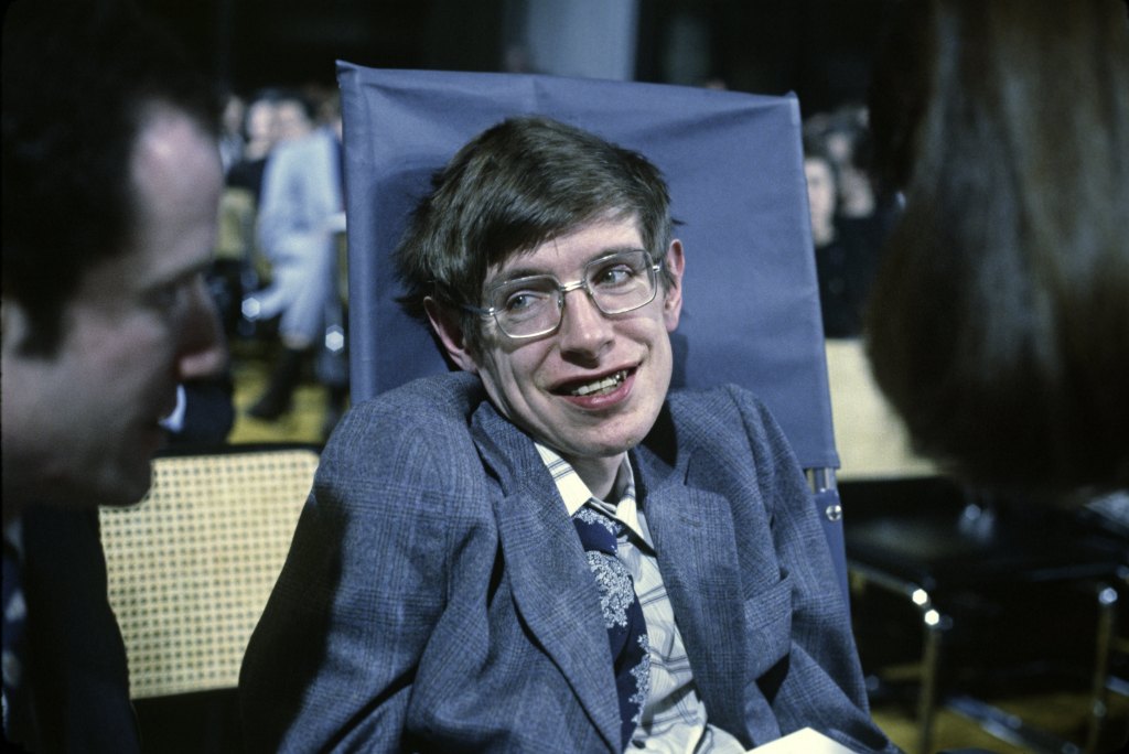 A man in a wheelchair hooked up to a respirator