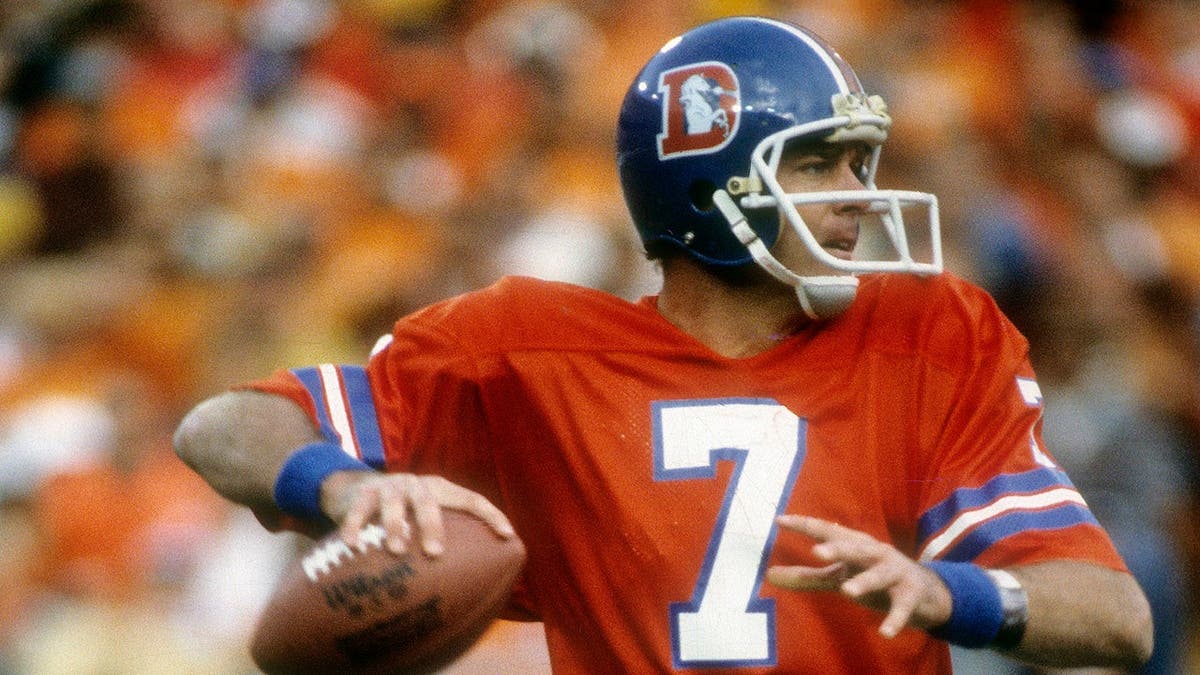 Quarterback Craig Morton dropping back to pass during an NFL game at Mile High Stadium