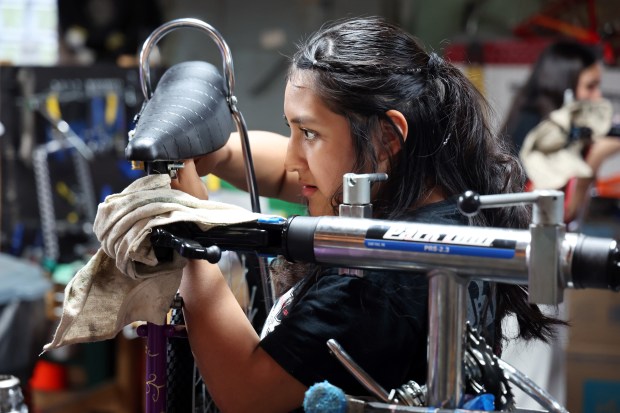 At Bikes N' Roses, a program at Communities United, Hailey Jurado works on her lowrider bicycle on May 12, 2026. The bike will be displayed at an upcoming mental health summit for young people. (Terrence Antonio James/Chicago Tribune)