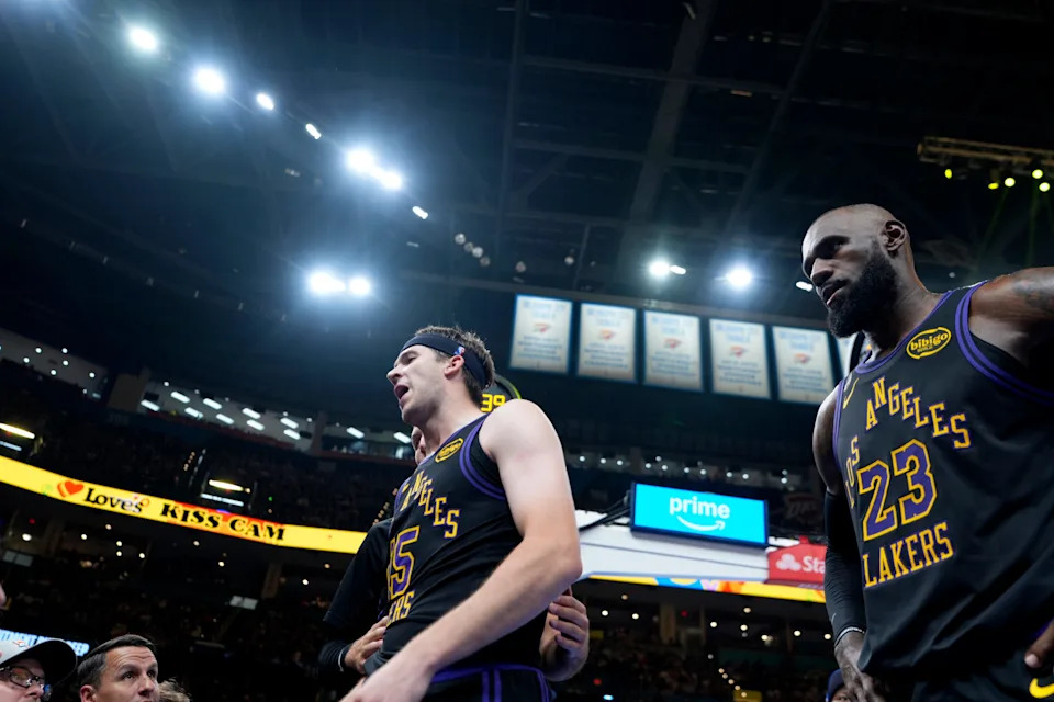 Los Angeles' Austin Reaves (15) and LeBron James (23) talks with fans during the NBA basketball game between the Oklahoma City Thunder and Los Angelos Lakers in Oklahoma City, Thursday April 2, 2026.