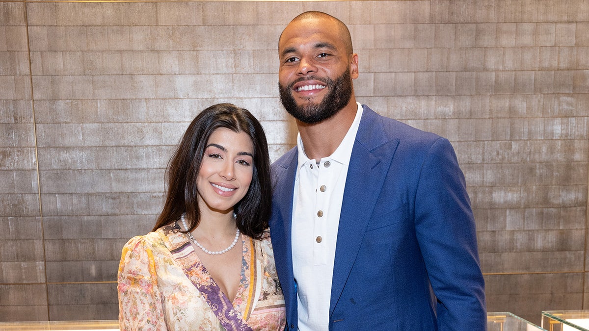 Dallas Cowboys Dak Prescott and Sarah Jane Ramos smiling at an in-store event