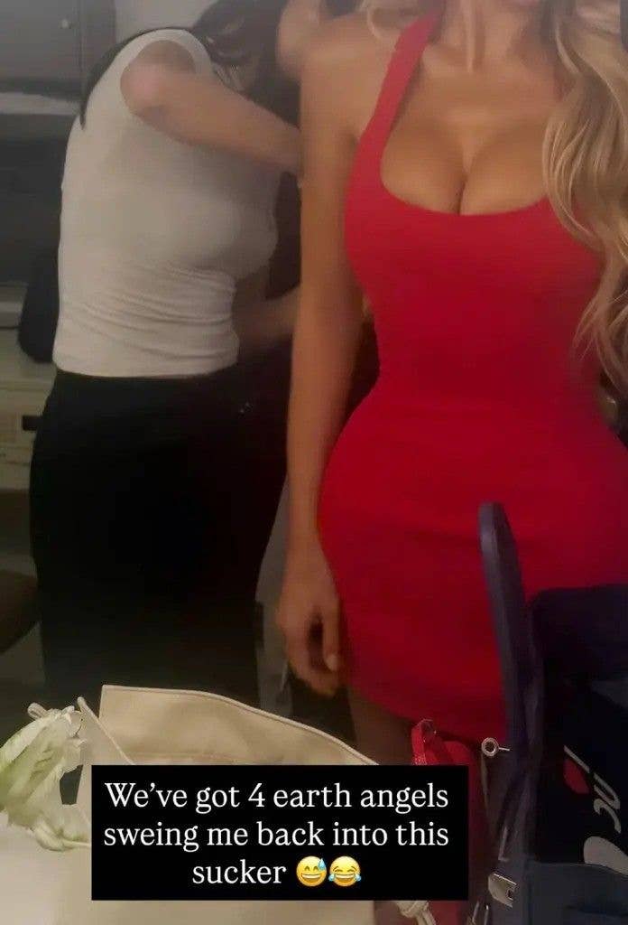 photo of brooks nader being sewn into red dress