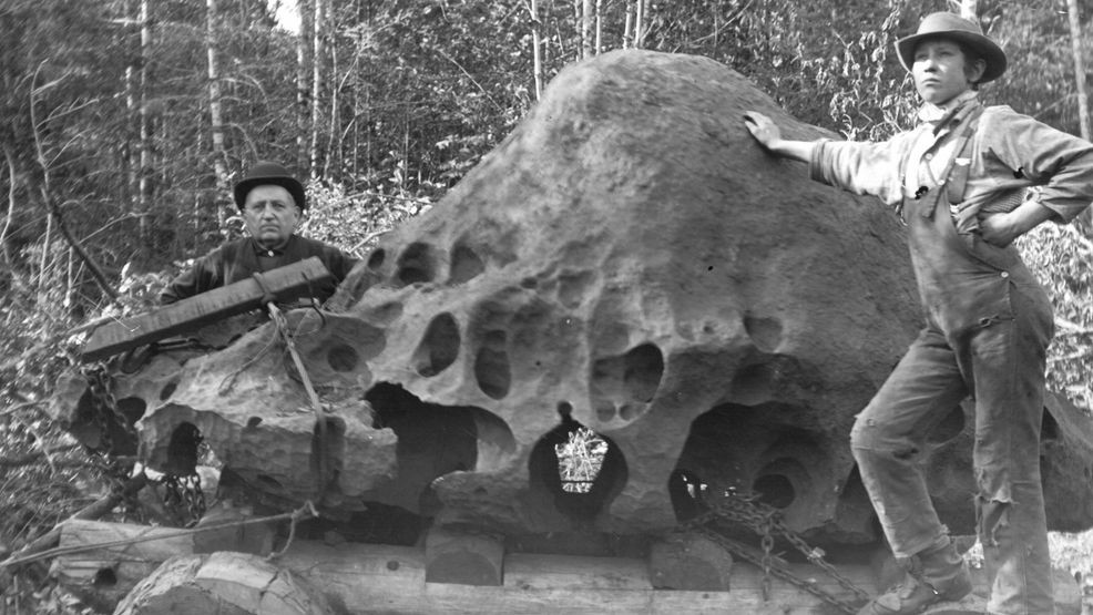 Two unidentified men stand next to the Willamette Meteorite. Courtesy: Oregon Historical Society