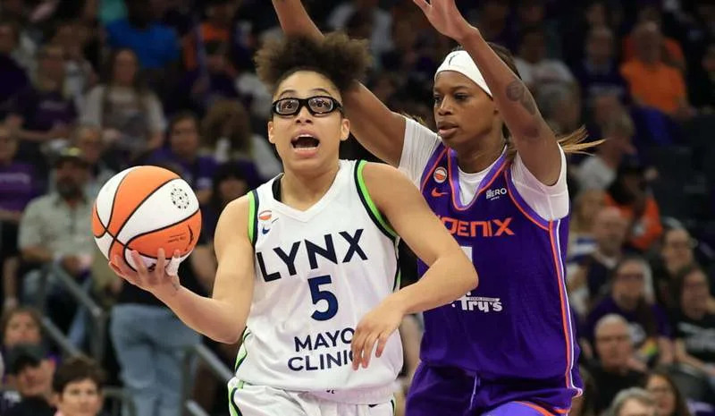 May 12, 2026; Phoenix, Arizona, USA; Minnesota Lynx guard Olivia Miles (5) drives to the basket against Phoenix Mercury forward Valeriane Ayayi (11) in the second half at Mortgage Matchup Center. Mandatory Credit: Mark J. Rebilas-Imagn Images
