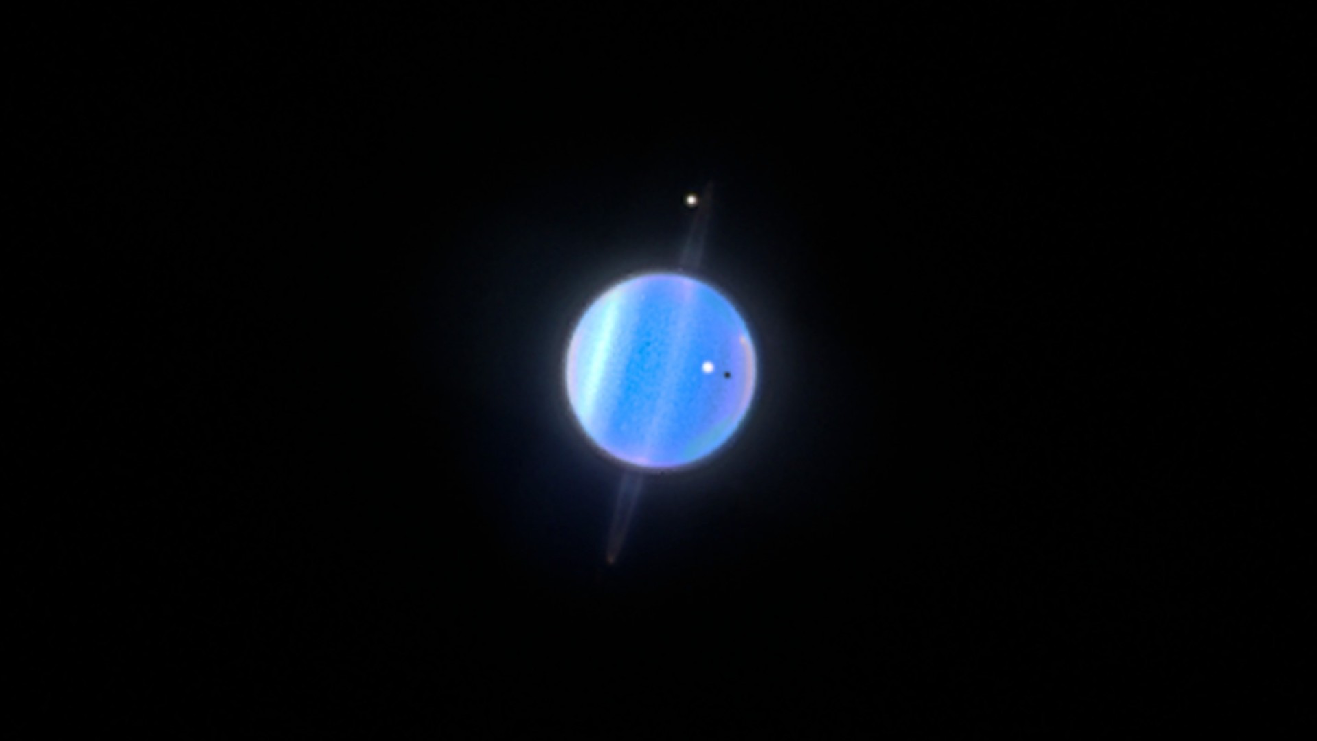 a blue orb surrounded by four smaller bright orbs on a black background
