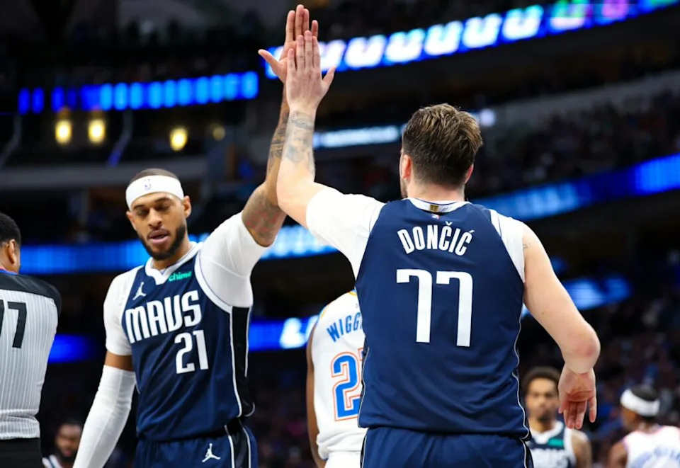 Dallas Mavericks guard Luka Doncic (77) celebrates with Dallas Mavericks center Daniel Gafford (21) during the second half against the Oklahoma City Thunder at American Airlines Center.