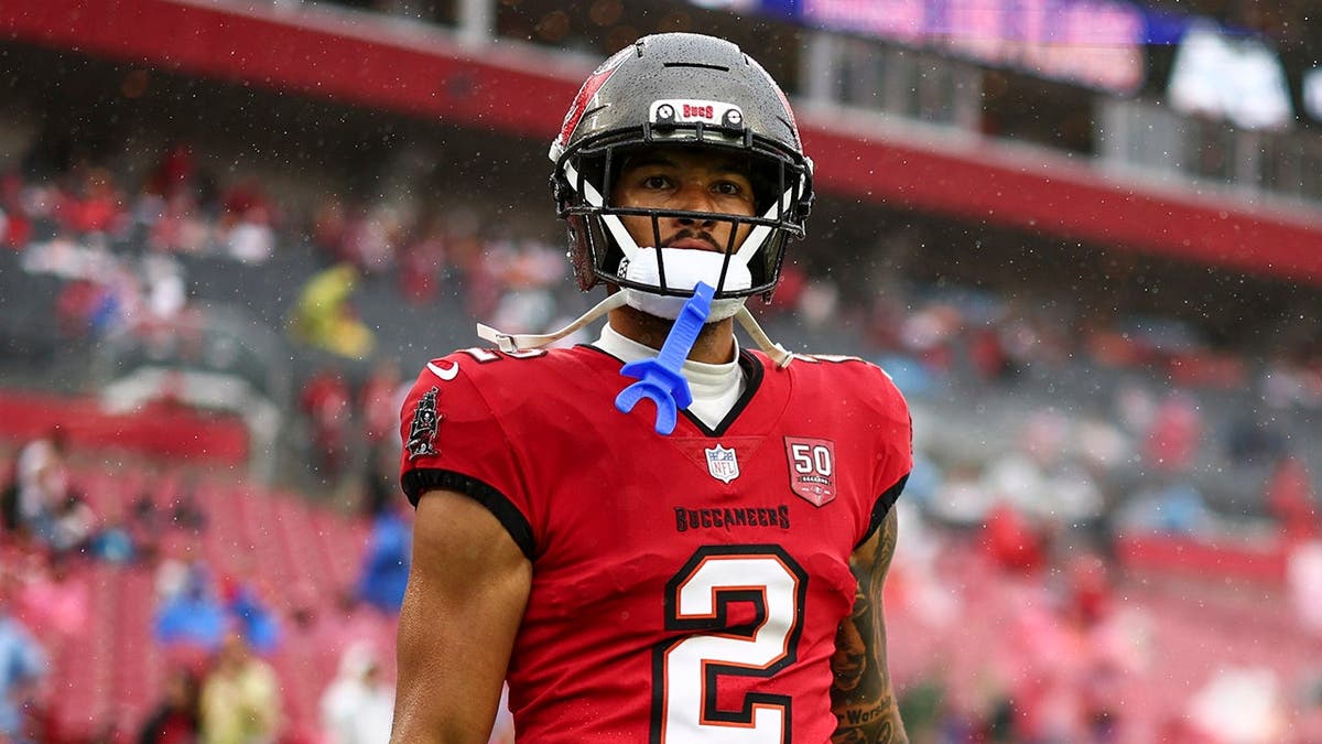 Emeka Egbuka walking on the football field at Raymond James Stadium.