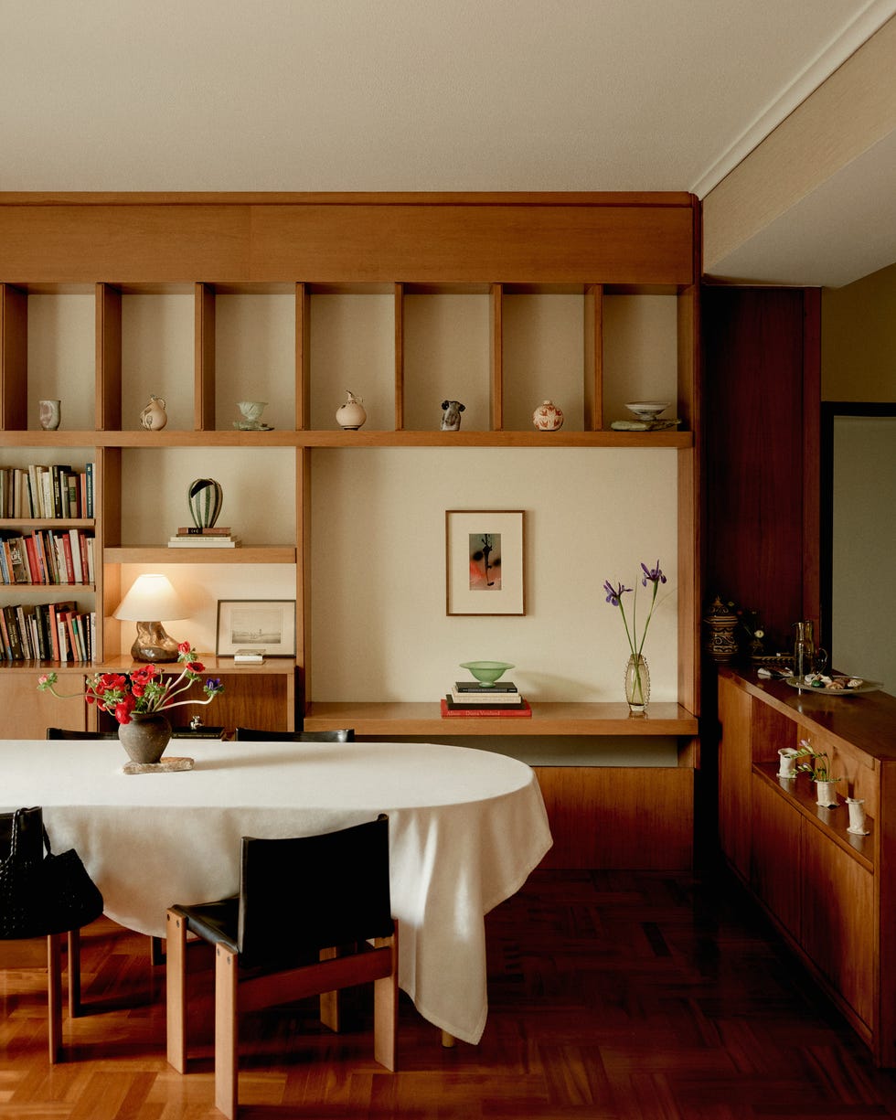 Modern dining area with a wooden shelf and decor.