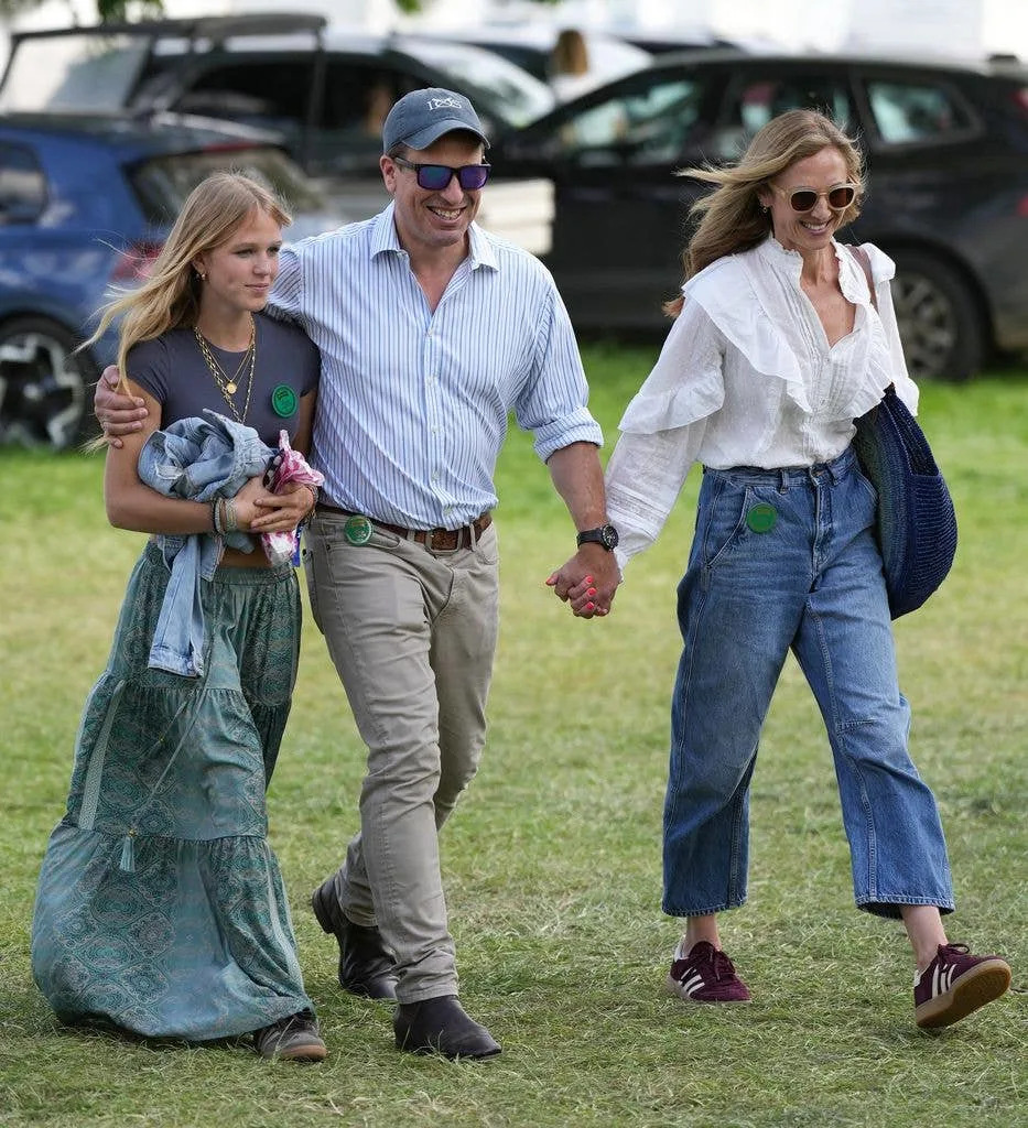 Peter and Harriet with Isla Phillips walking holding hands