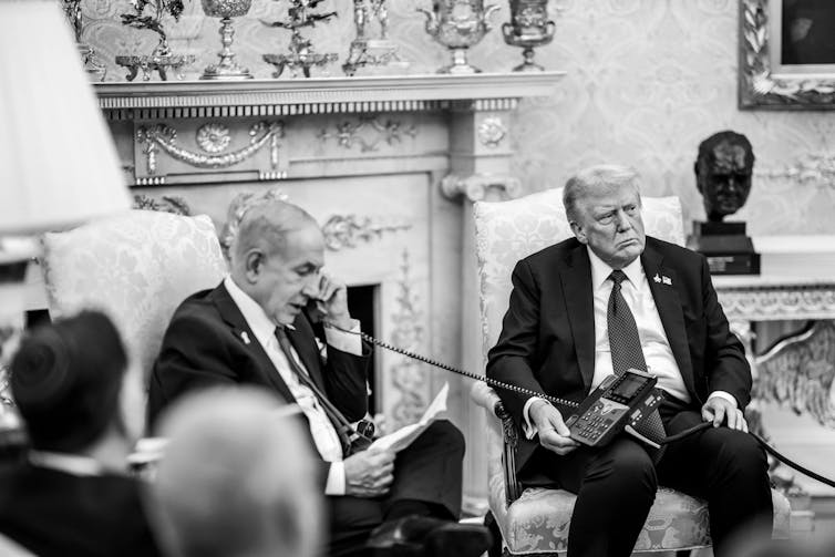 Benjamin Netanyahu calls Sheikh Mohammed bin Abdul Rahman Al Thani from the White House with Donald Trump watching on.