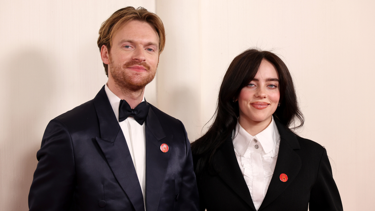 Finneas O'Connell and Billie Eilish standing together at the Academy Awards event.