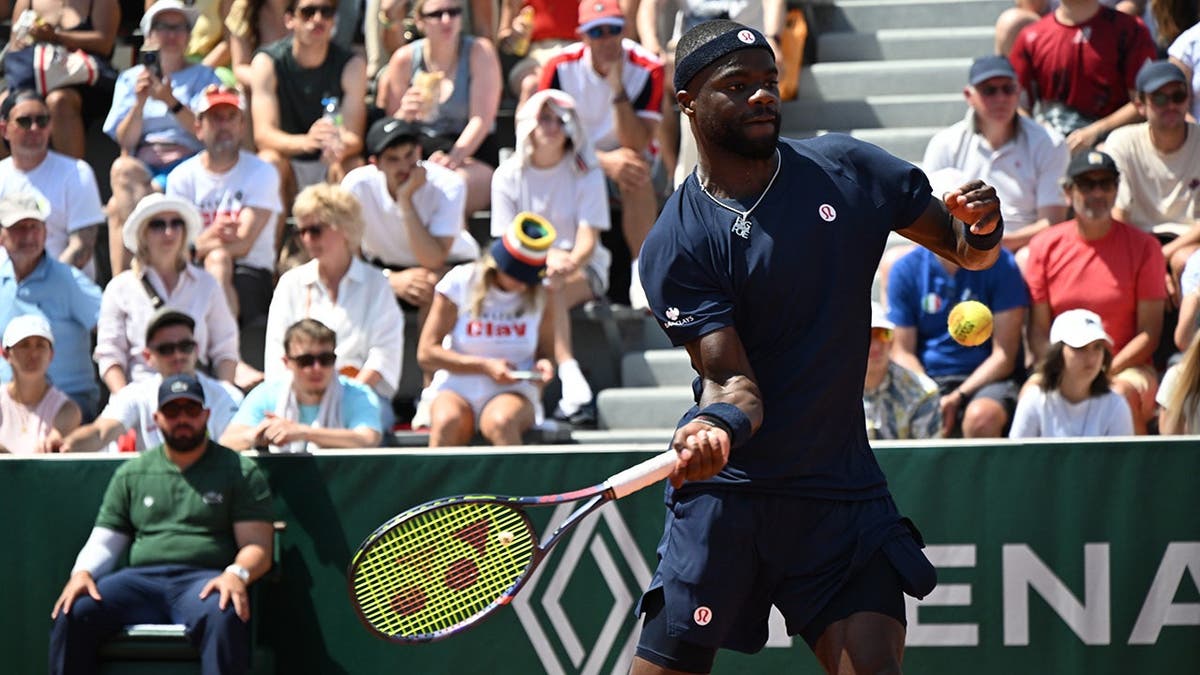 Frances Tiafoe returning a tennis ball to Hubert Hurkacz during a match