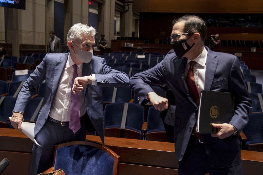 Jerome Powell and then-Treasury Secretary Steven Mnuchin greet each other with an elbow bump during a House Financial Services Committee hearing in Washington, DC, on June 30, 2020.