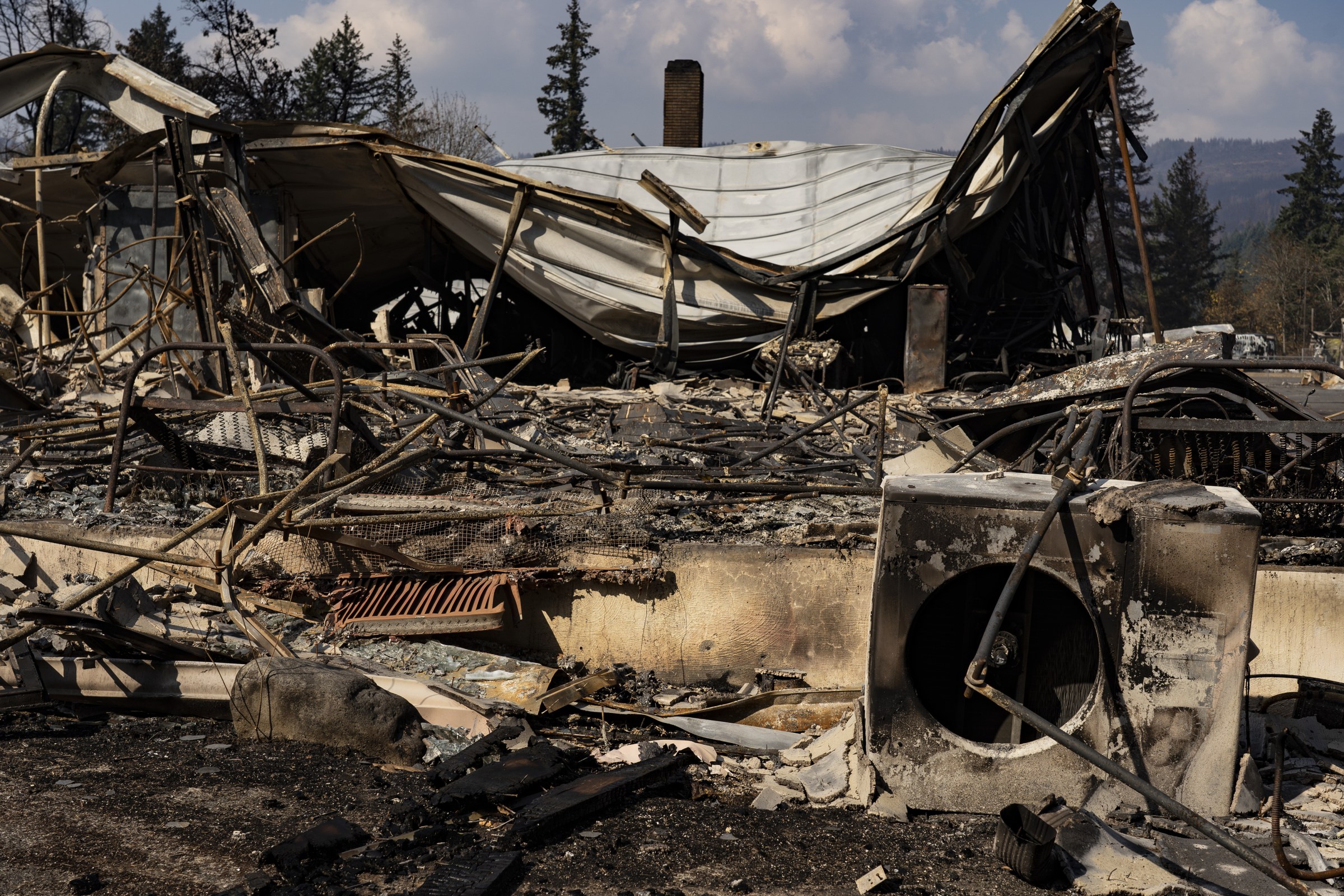 a burned building with twisted metal and charred pieces
