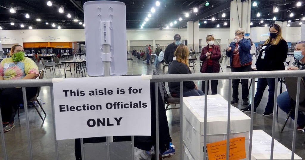 Election officials listen as procedural issues are argued during a ballot recount at the Wisconsin Center in Milwaukee, Wisconsin, on Nov. 20, 2020.