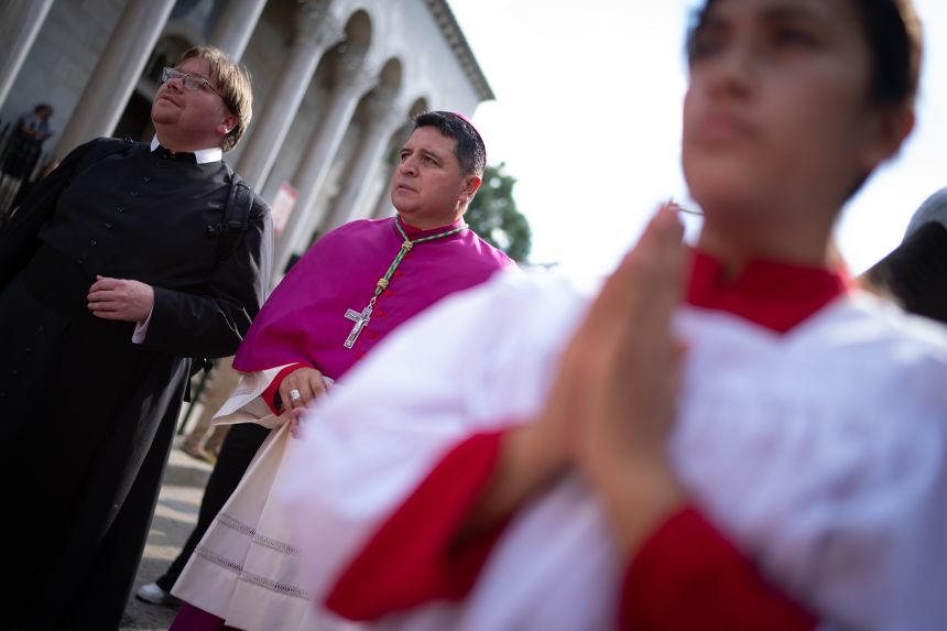 Bishop Evelio Menjivar-Ayala, center, walks in the first Reflection Procession through Washington, DC, on September 28, 2025, in observance of the 111th World Day of Migrants and Refugees.