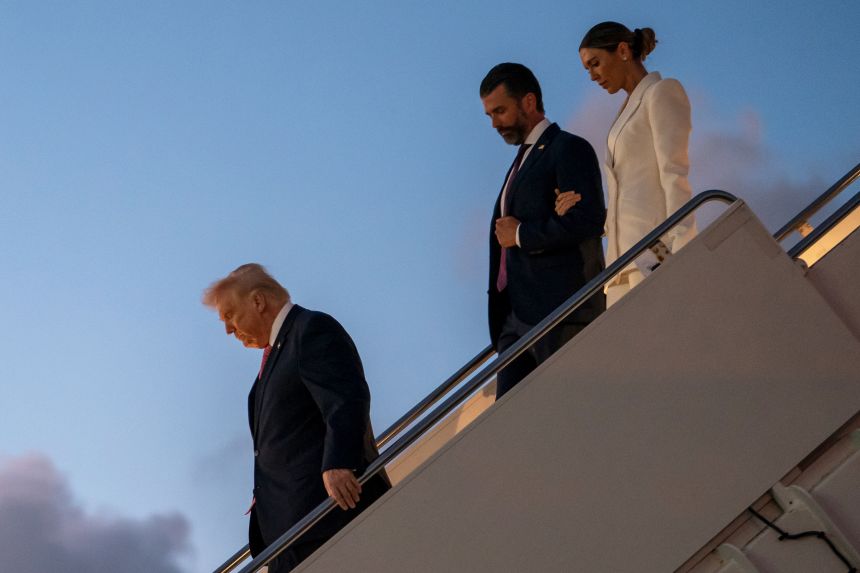President Donald Trump exits Air Force One along with his son Donald Trump Jr. and Bettina Anderson while arriving at Palm Beach International Airport on March 27 in West Palm Beach, Florida.