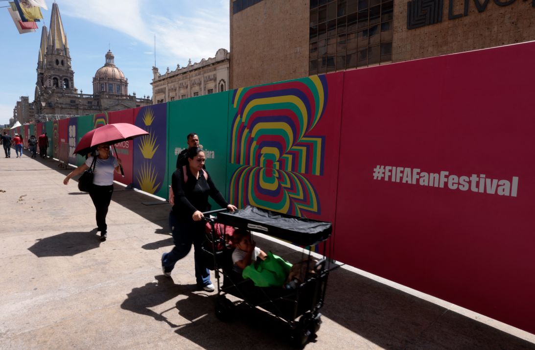 People pass by advertising marking the perimeter of the