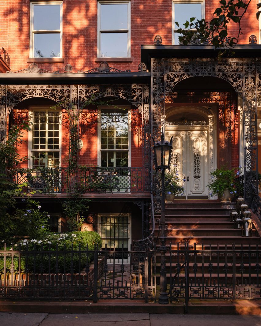 Exterior of Harper House with a wrought iron porch and stoop
